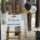 Wooden easel displays a "Welcome to our Rutherford Graduation" sign. Beside it, black, yellow, and white balloons add a celebratory touch.